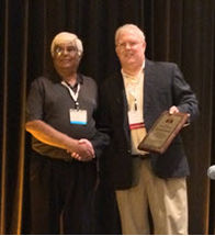 Mustafa Rehmanji receiving his award from MBAA President, Tom Eplett.