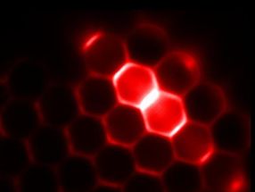 Continuously emitting microlasers with nanoparticle-coated beads