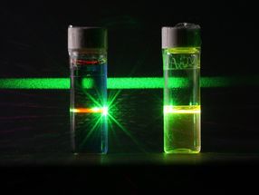 Grüne Fluoreszenz einer Farbstofflösung, die mit blauem Licht angeregt wird.