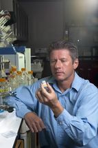 Ronen Polsky holds a prototype of a microneedle fluidic chip device